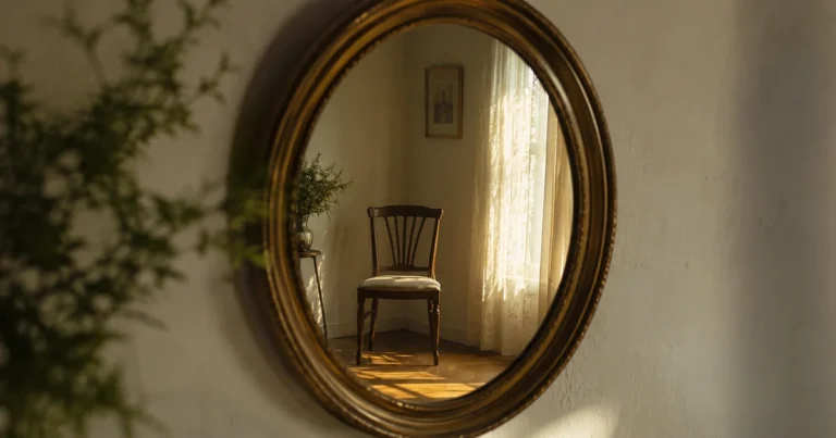 A single mirror reflecting an empty chair rather than the viewer in soft afternoon light