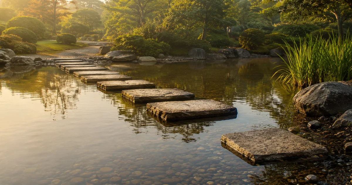Flat stepping stones placed across a garden pond, the last one only halfway laid