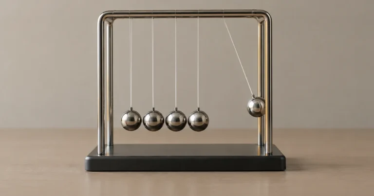 A five-ball Newton's cradle on a plain surface, with one outer ball slightly displaced